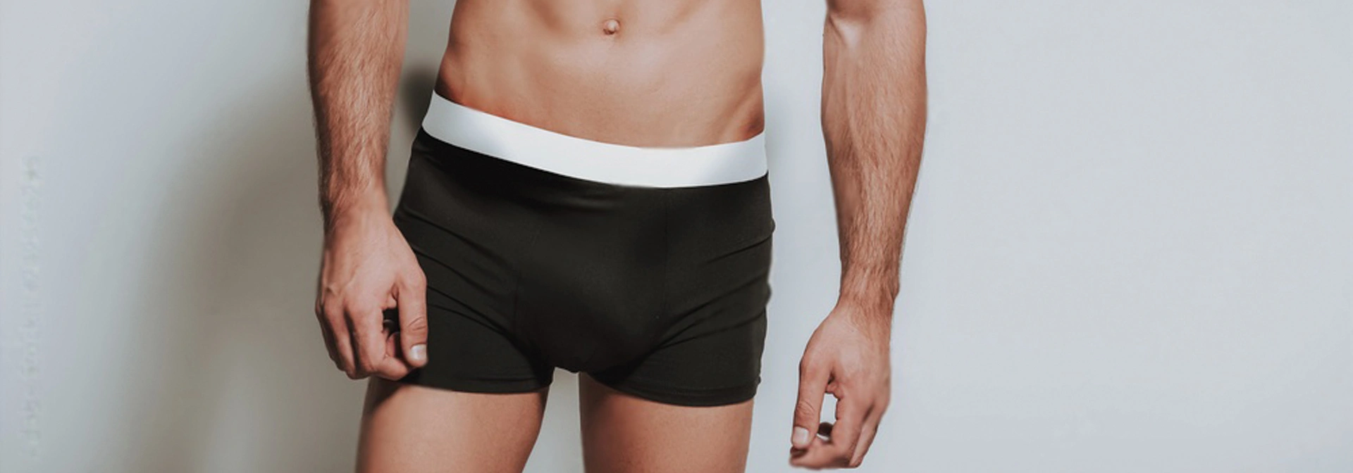 man standing in black underwear
